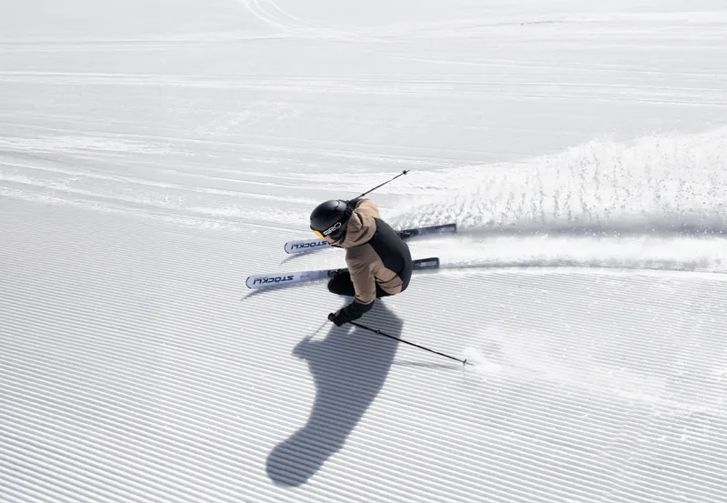 Skier carving on freshly serviced skis